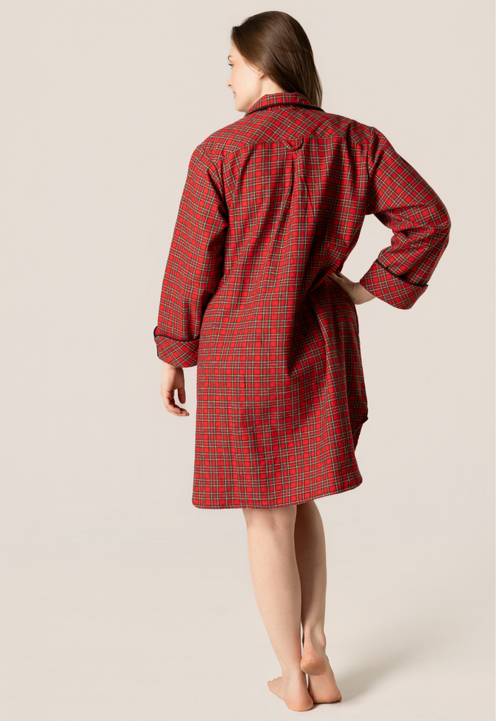 Woman wearing a red plaid nightshirt against a beige background