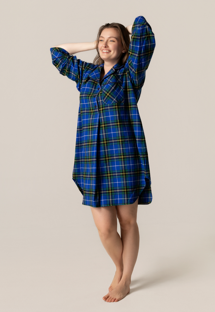 Woman wearing a nova scotia tartan nightshirt against a beige background