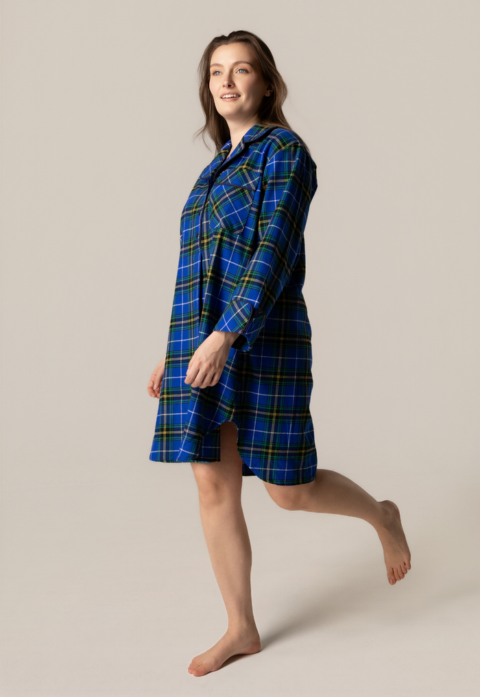 Woman wearing a blue plaid nightshirt on a beige background