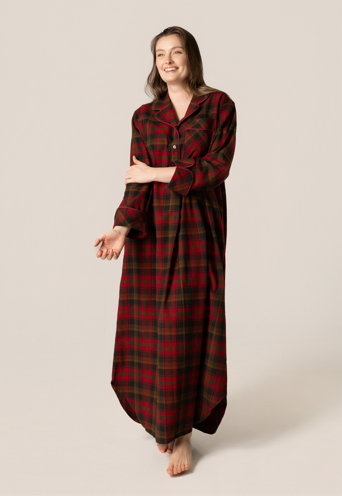 Woman wearing a red plaid nightgown on a beige background