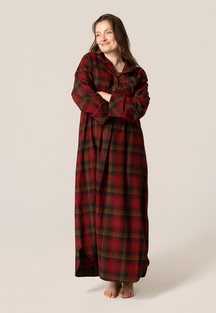 Woman wearing a long maple leaf tartan nightshirt on a beige background