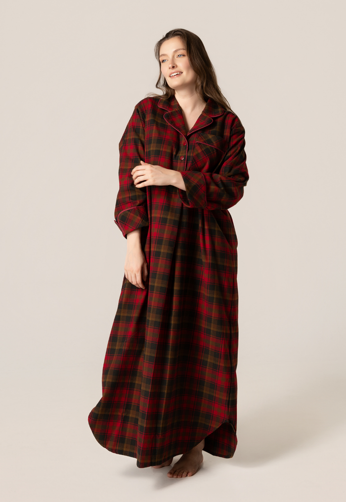 Woman wearing a maple leaf tartan nightshirt against a beige background