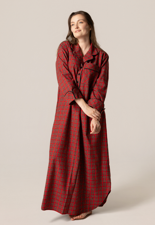 Woman wearing a red plaid nightgown against a plain background