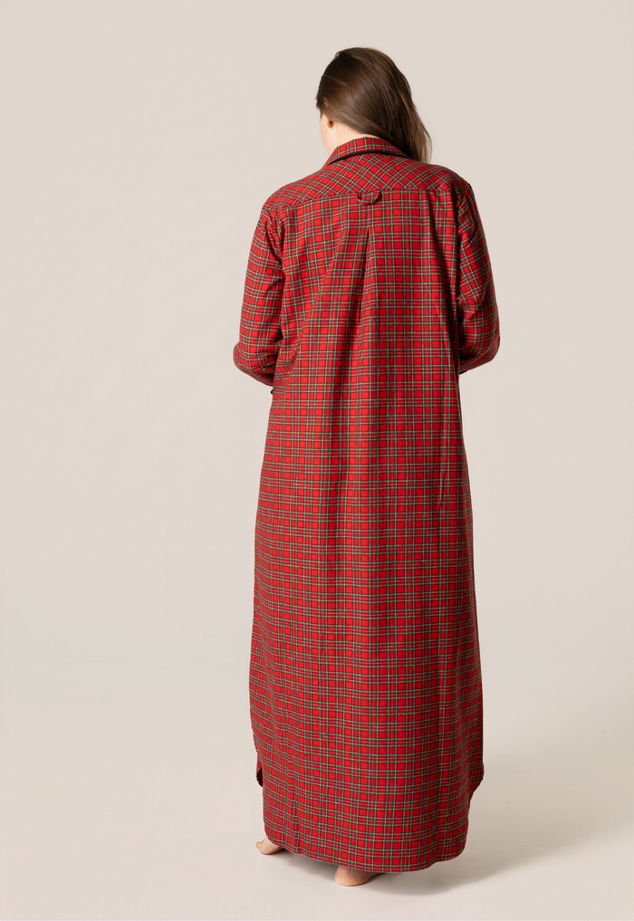 Person wearing a red plaid flannel nightgown against a beige background