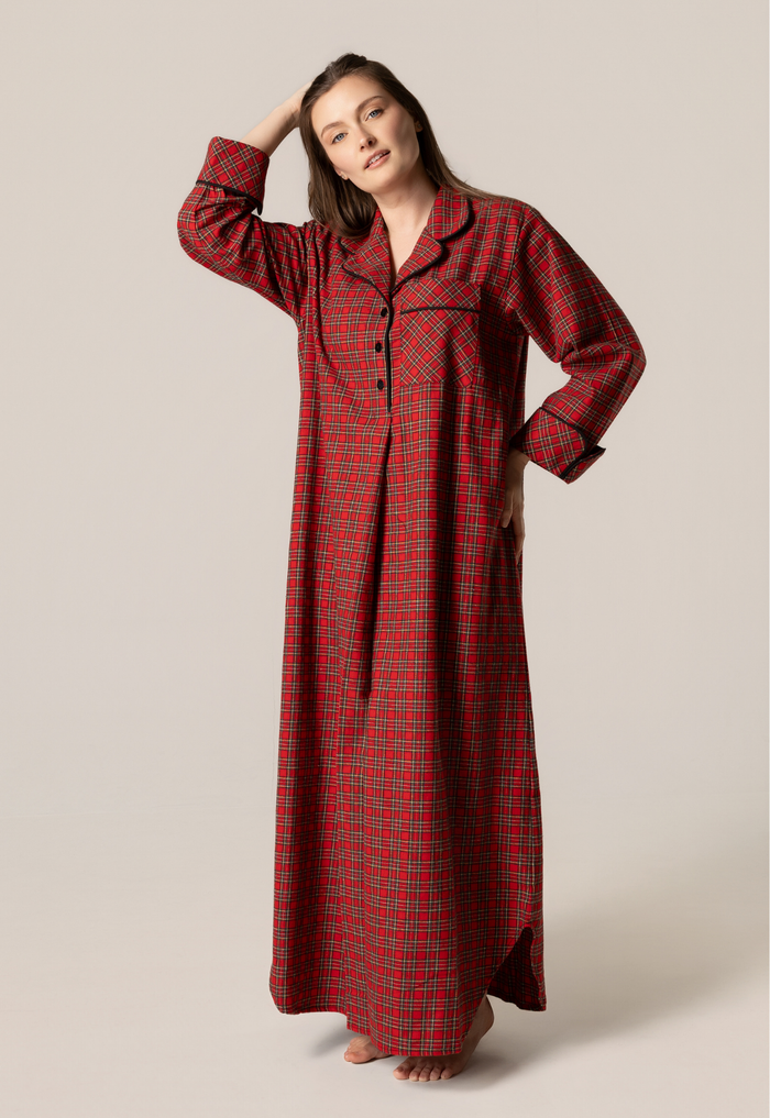 Woman wearing a red plaid nightgown against a beige background