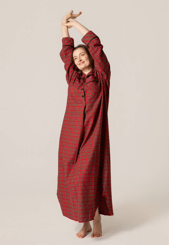 Woman wearing a red checkered dress against a beige background