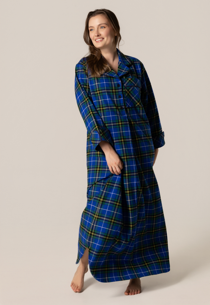 Woman wearing a blue plaid robe on a plain background