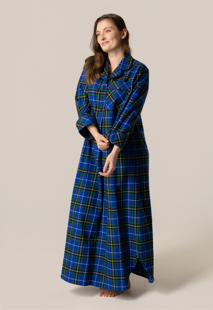 Woman wearing a blue and green plaid nightgown against a plain background