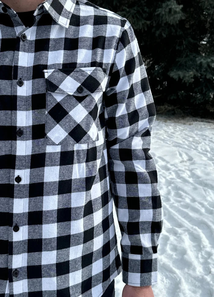 Classic Black and White Buffalo Check Shirt taken outside in the snow in Banff, Canada. The shirt has 2 front pockets and is fitted.