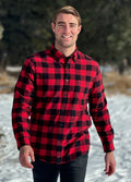 A man wearing a classic Canadian red and black buffalo check button-down shirt with a single pocket on the chest. This shot is taken in Banff National Park