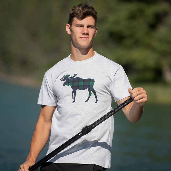 Man wearing a t-shirt with a moose graphic outdoors