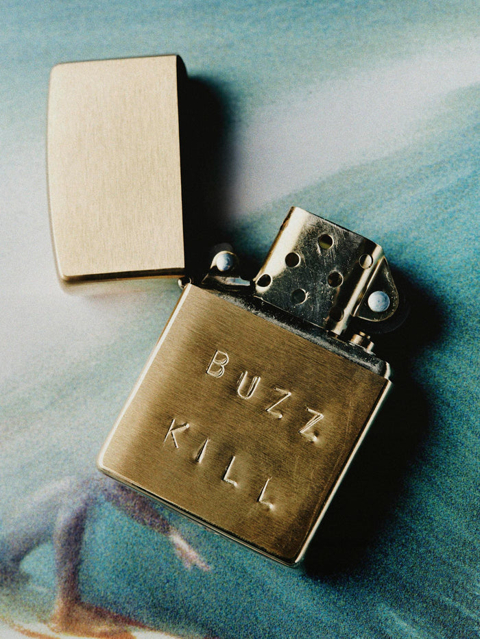Black hand stamped “buzz kill” zippo