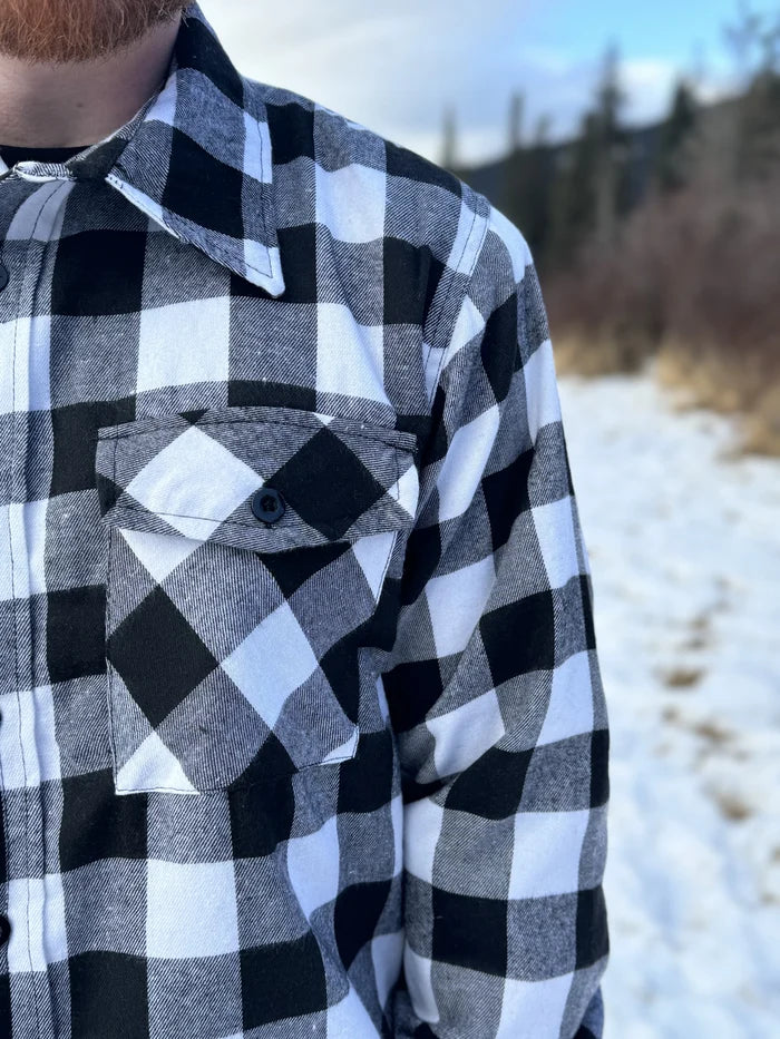 The outer layer is flannel, and the inside is a lightweight fibre quilted layer. Wear it on its own or as a layering piece!